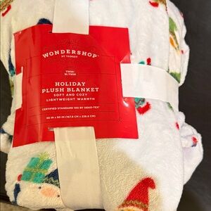 Wondershop Festive Plush Blanket - White with Red and Blue Accents.